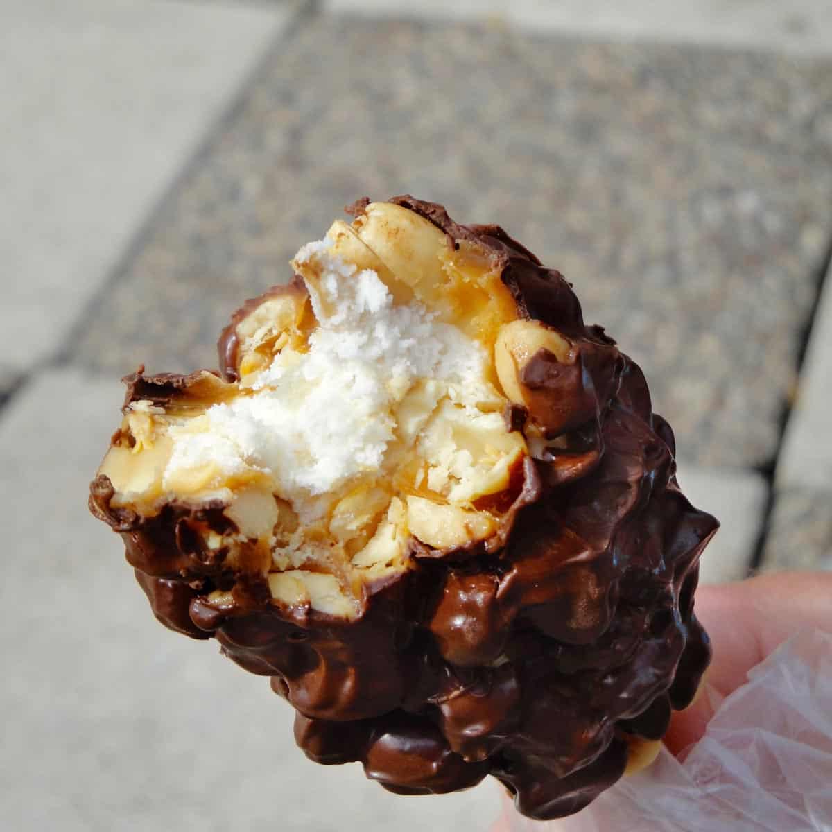 homemade nutroll on a stick, with a bite out of it