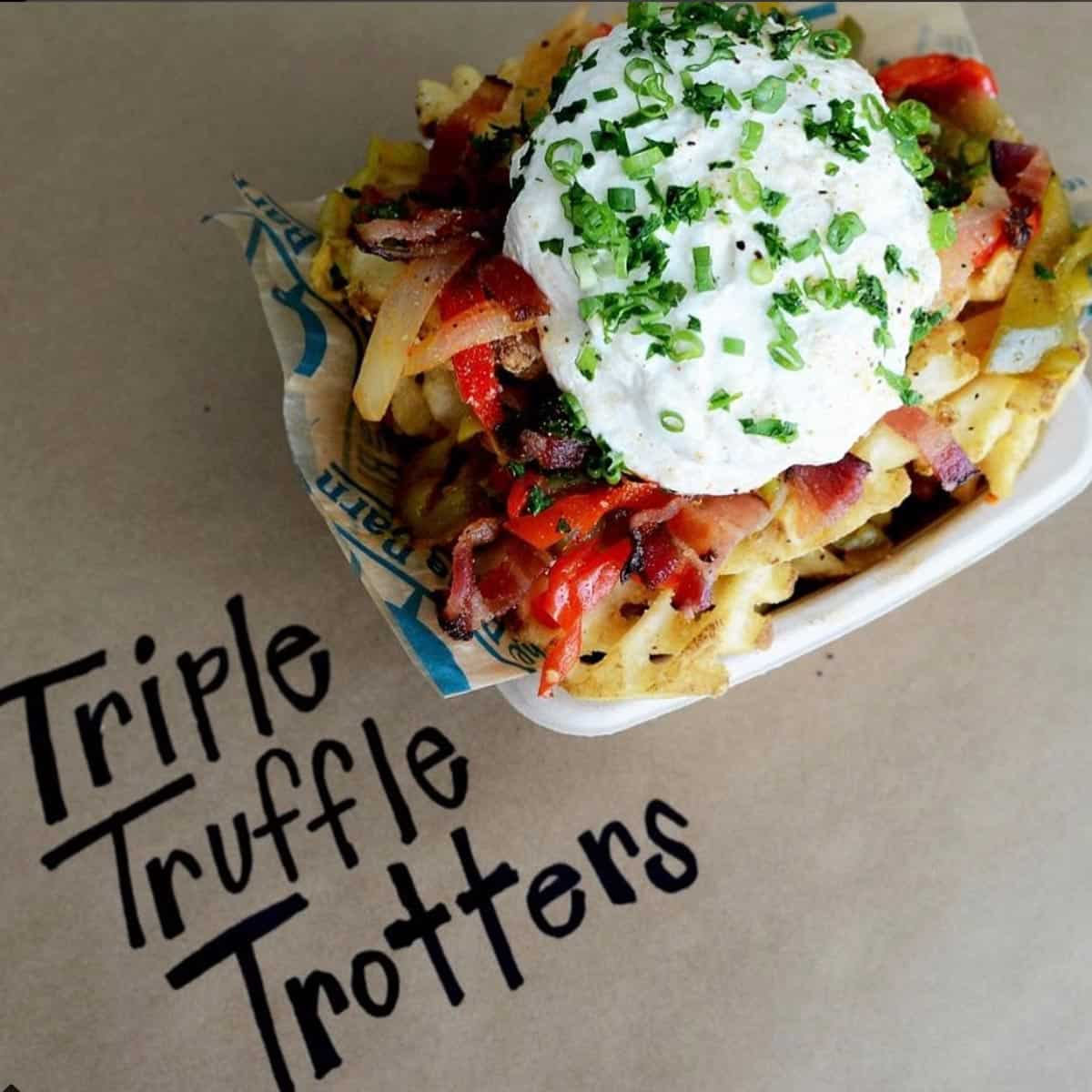 a paper basket of triple truffle trotters