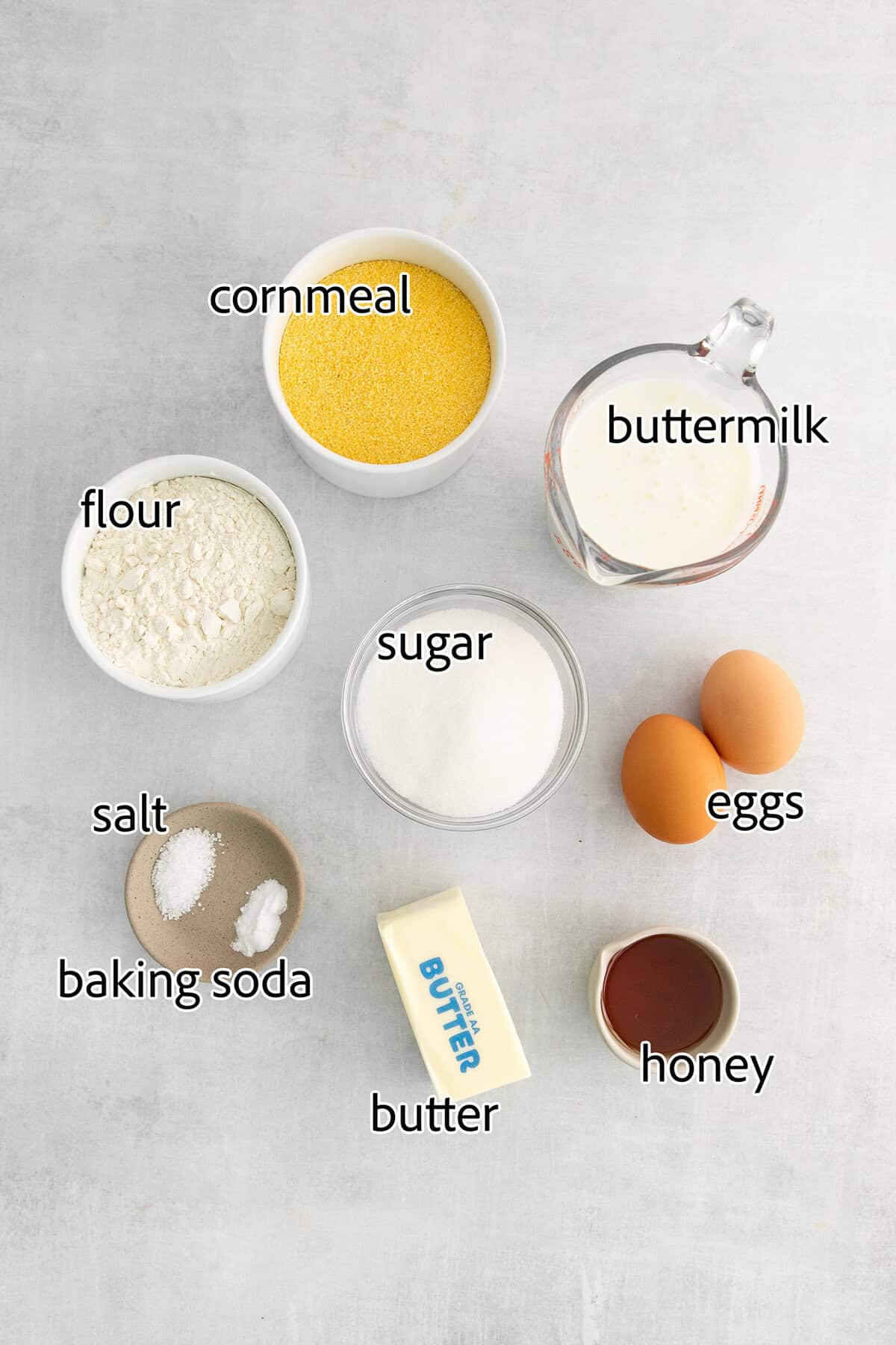 Labeled ingredients for making honey cornbread muffins. 