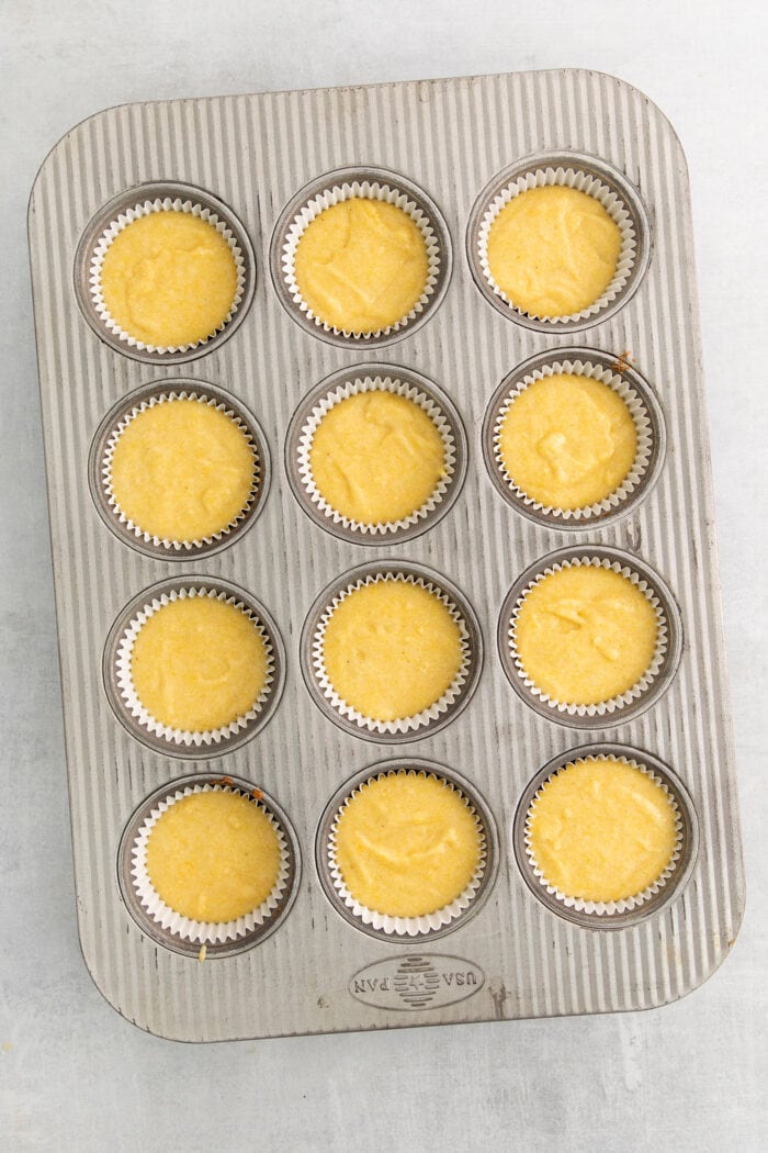 Muffin tray filled with muffin batter.