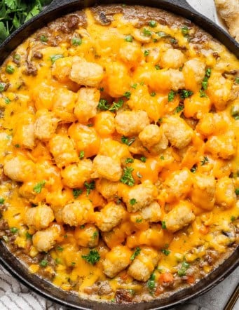 Overhead view of tater tot hotdish in cast iron skillet