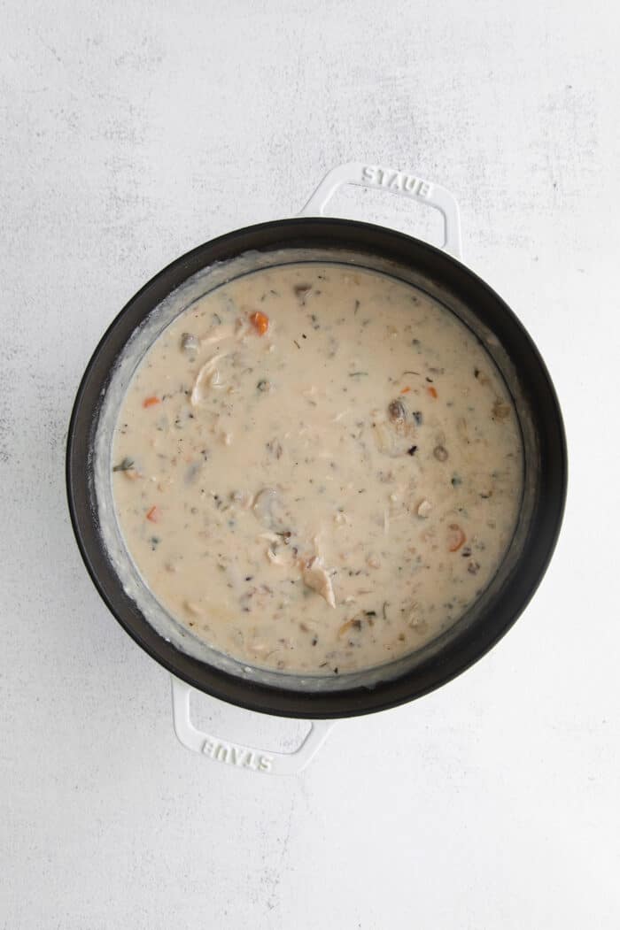 Overhead view of chicken and wild rice soup in a pot.