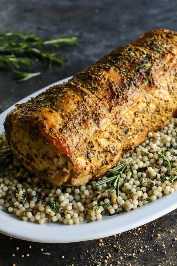 Mustard Pork Loin Roast from afarmgirlsdabbles.com - This pork loin roast is wonderfully tender and flavored with an ultra tasty mustard sauce. The dish is easy enough for a weeknight meal and definitely pretty enough to serve for holidays and special occasions. #pork #loin #roast #mustard #rosemary 