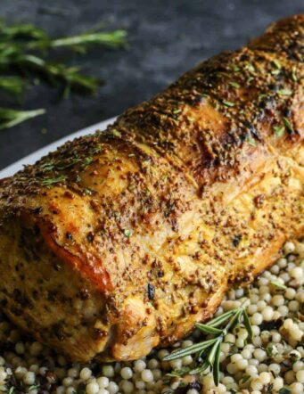 Mustard Pork Loin Roast on top of a layer of couscous