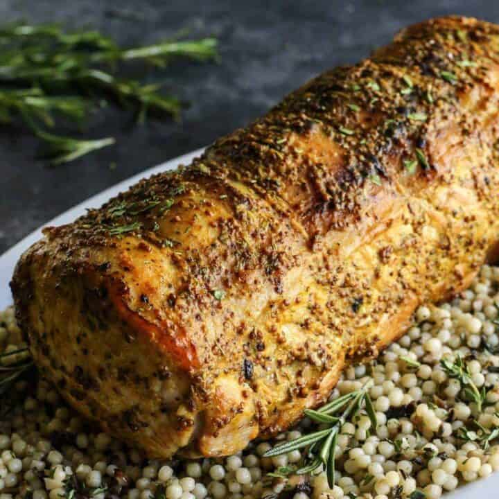 Mustard Pork Loin Roast on top of a layer of couscous