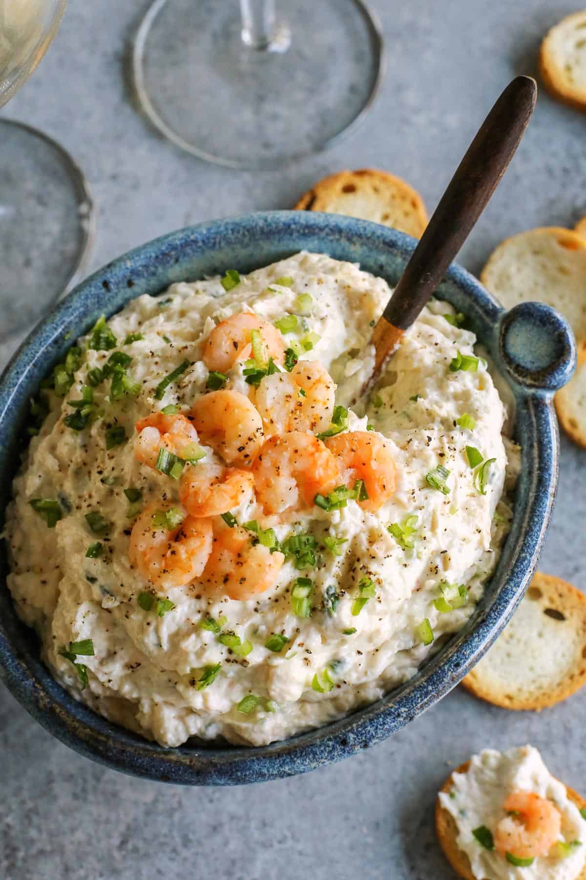 This shrimp dip recipe is an easy appetizer, made with just a few ingredients. It's thick and creamy, and full of tender, juicy shrimp! Bowl of cold shrimp dip.