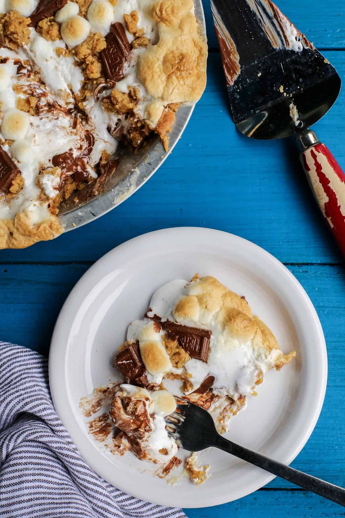 a slice of S'mores Pie on a white plate