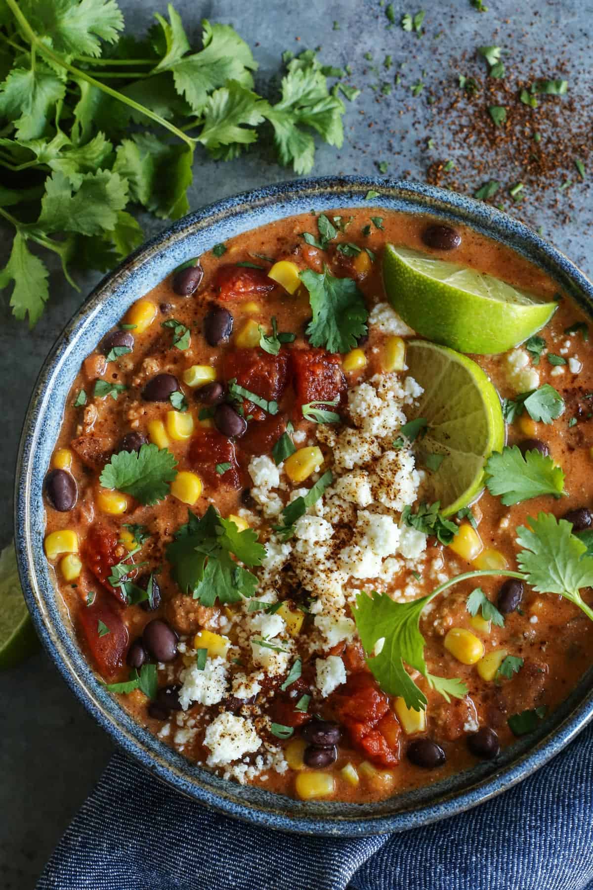 Creamy Enchilada Chili is brimming with tasty bites. In every spoonful, you'll savor the flavors of enchiladas...without tortillas! Creamy Enchilada Chili in a blue bowl