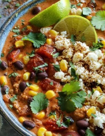 creamy chili with cheese and line wedges