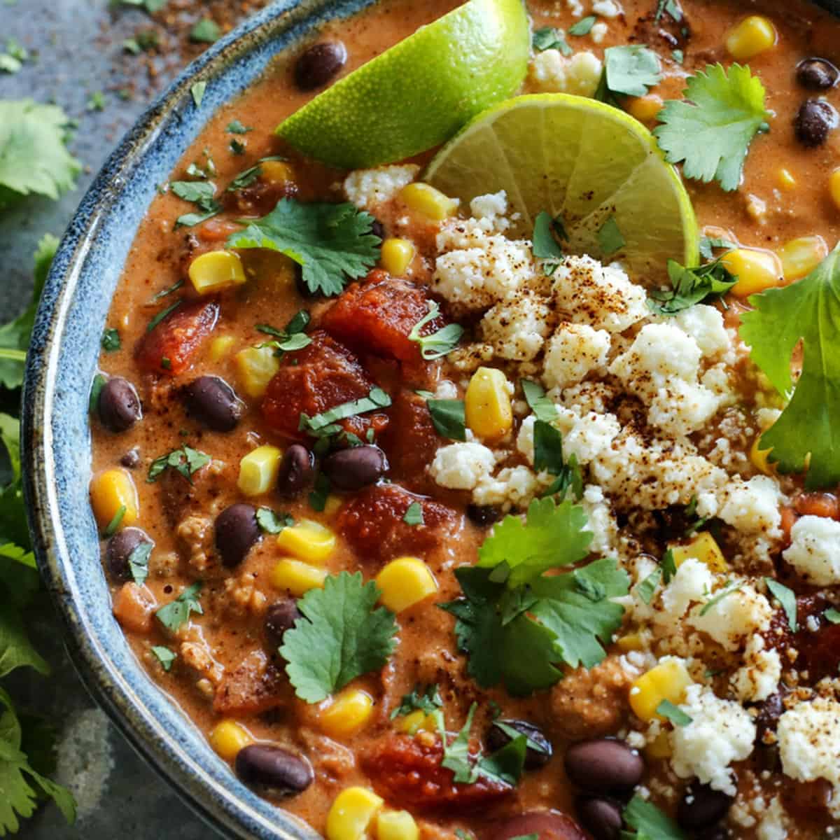 creamy chili with cheese and line wedges