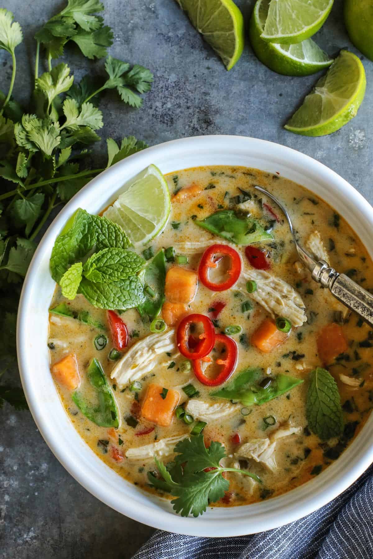 Overhead view of Thai Chicken Soup in a white bowl.