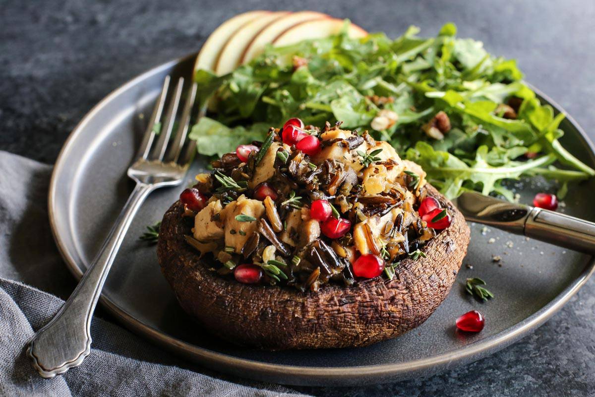 Turkey Wild Rice Stuffed Portobello Mushroom on a plate with a side salad