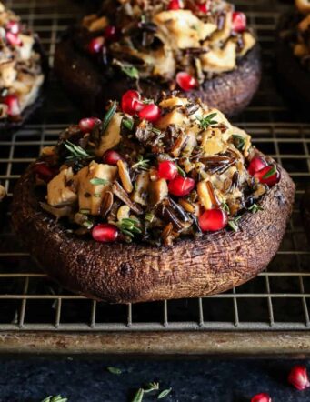 portobello mushrooms stuffed with wild rice and turkey on a pan