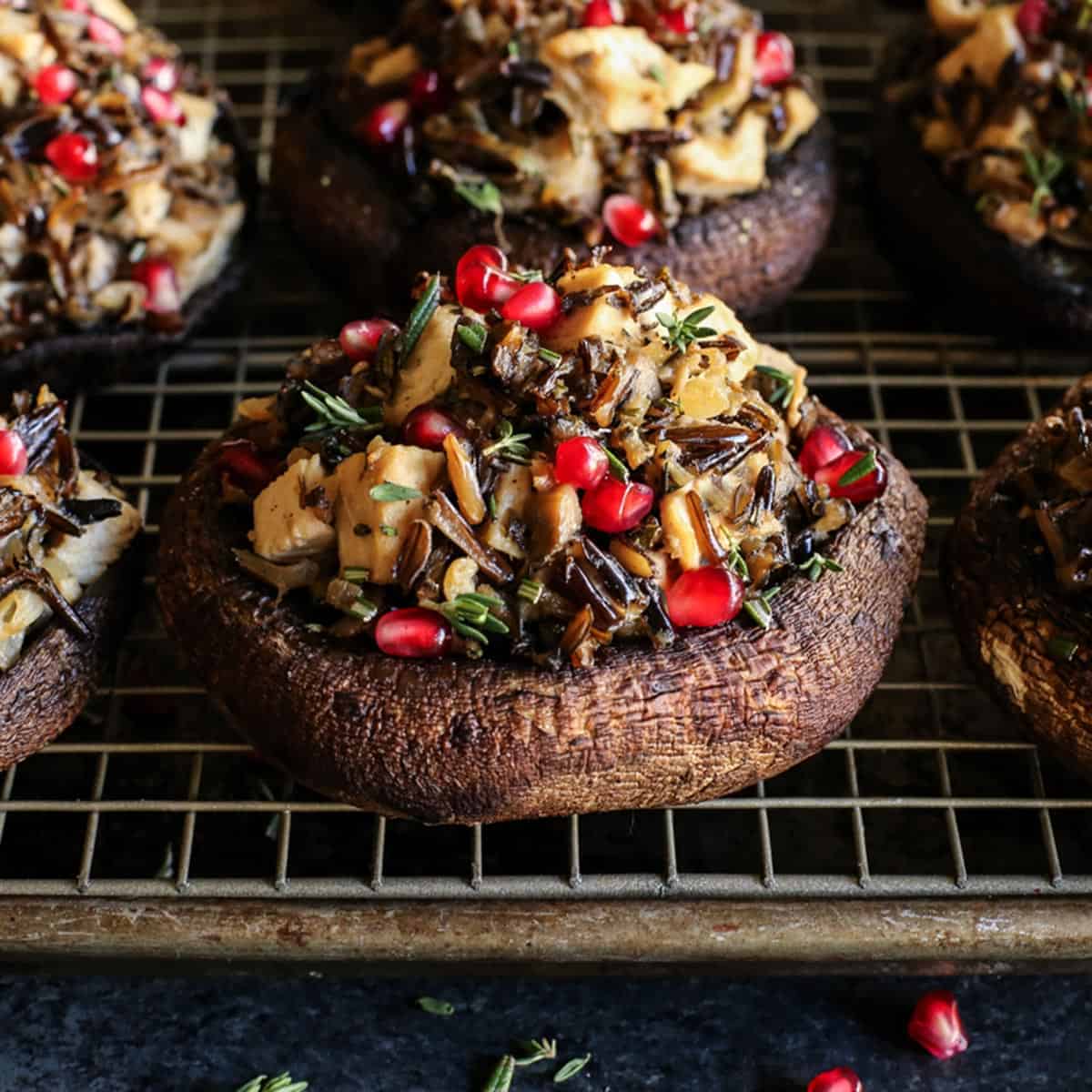 portobello mushrooms stuffed with wild rice and turkey on a pan