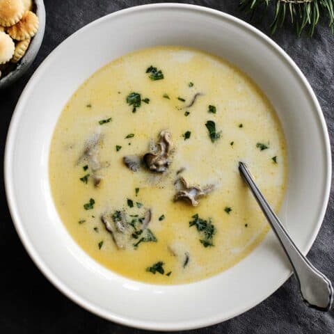 Overhead view of oyster stew in a white bowl