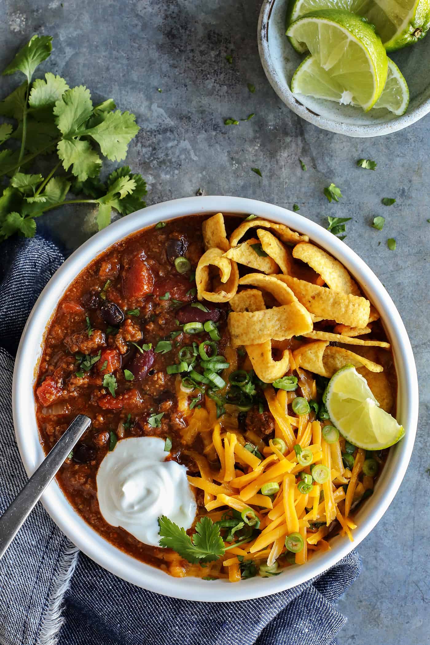 This Slow Cooker Chili recipe has been in my family for years! It's an easy, homemade chili cooked in the crockpot & packed with flavor. Overhead view of a bowl of crockpot chili
