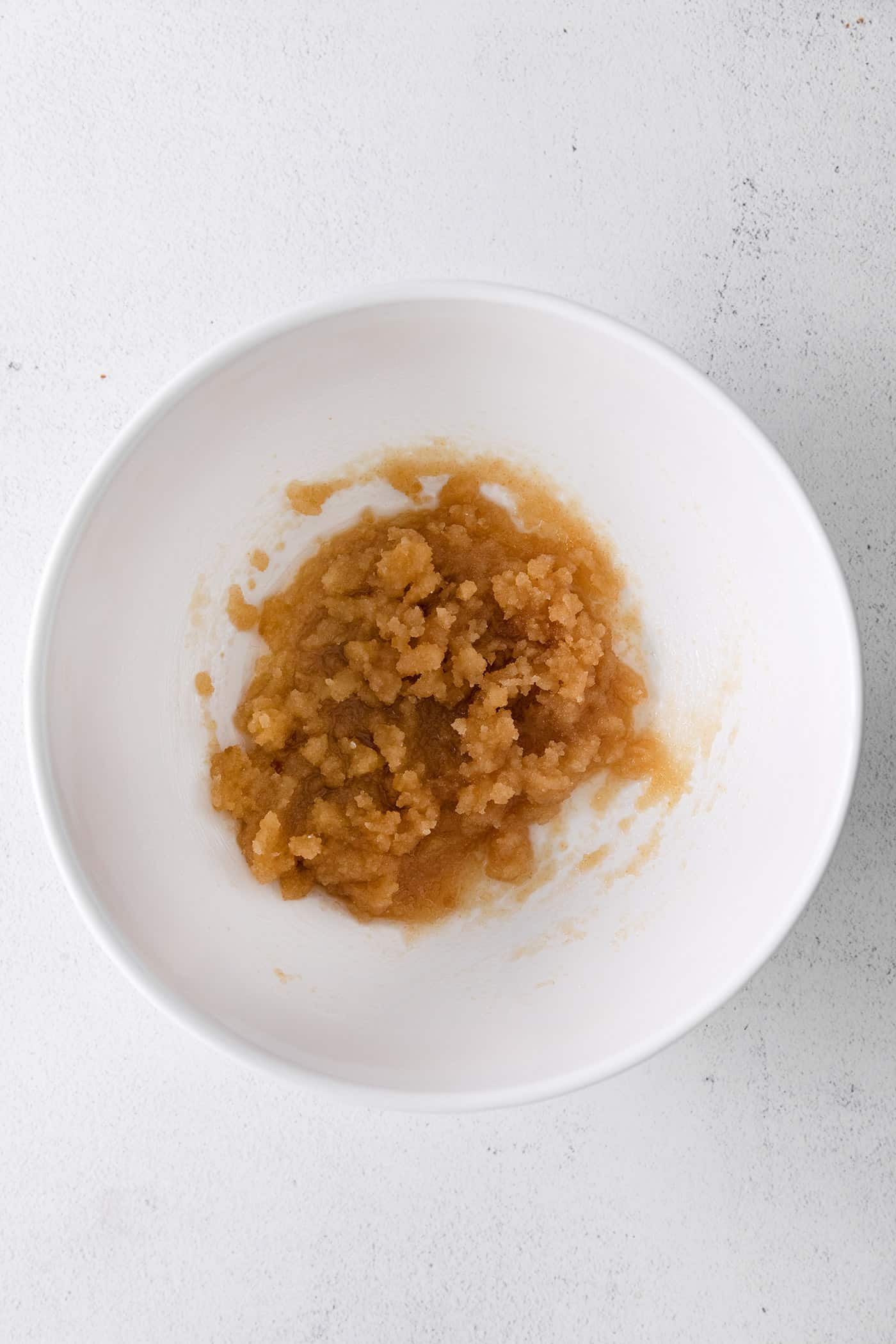 Creamed butter and brown sugar in a white bowl
