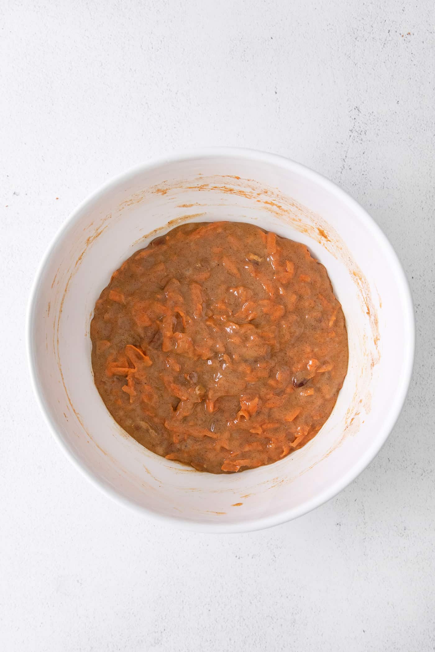 Carrot cake batter in a white bowl