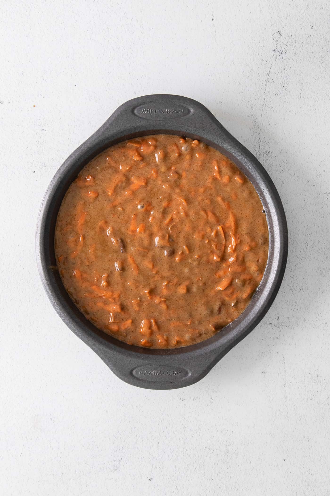 Carrot cake batter in a silver cake pan