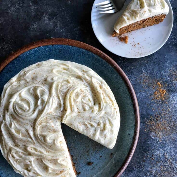 Carrot Cake with cream cheese frosting on a blue platter