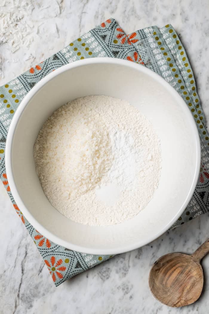 Overhead view of dry ingredients in bowl for coconut cupcakes
