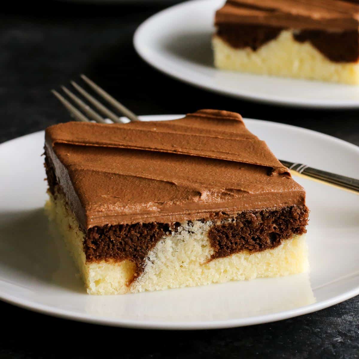 two pieces of marble cake on plates