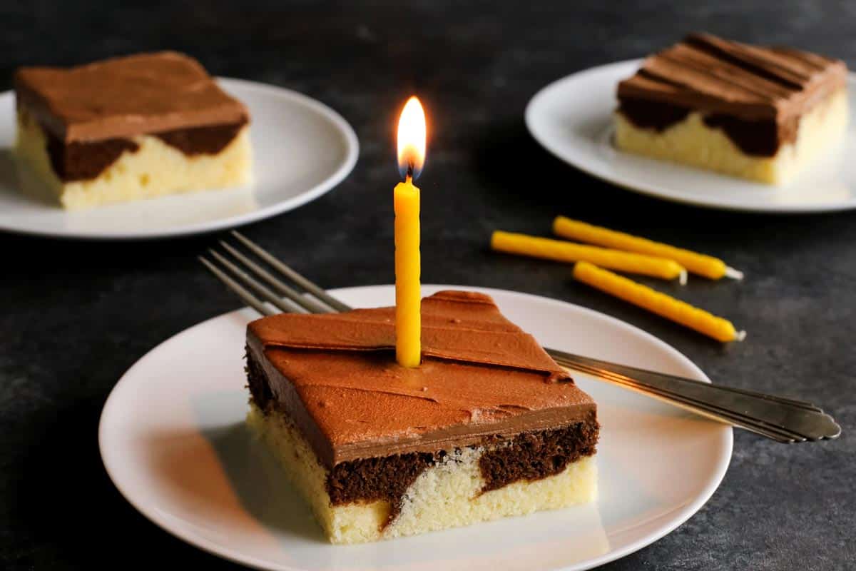 piece of marble cake with a yellow candle