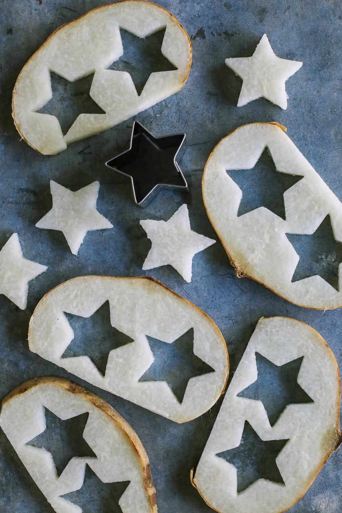 cutting out stars from slices of jicama