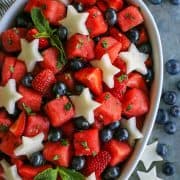 white oblong serving bowl of fresh fruit salad