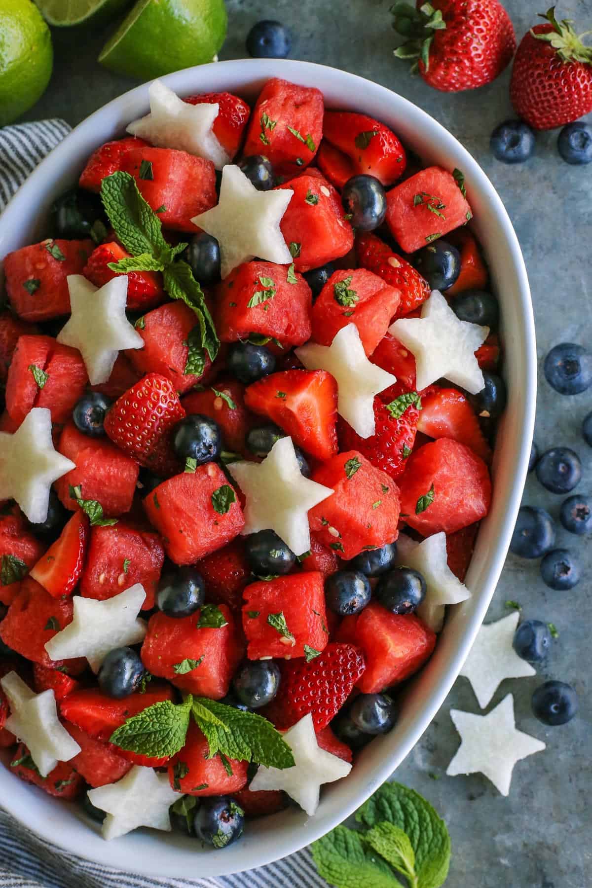 white oblong serving bowl of fresh fruit salad