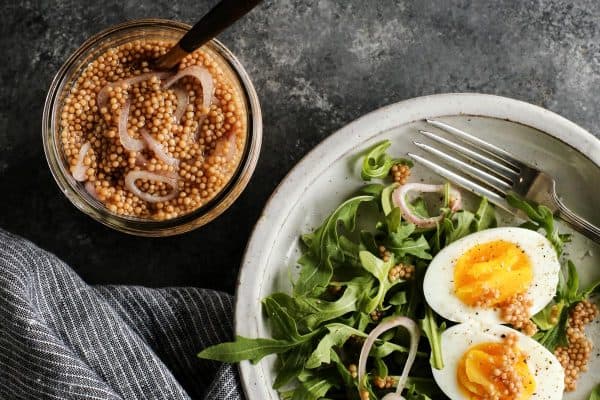 pickled mustard seeds with eggs and a side salad