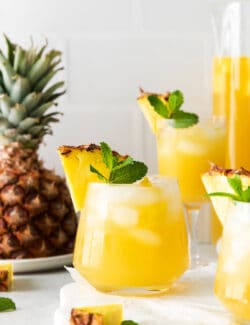 Angled view of pineapple sangria with bourbon in glasses