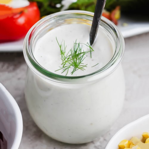 Jar of buttermilk ranch dressing with spoon