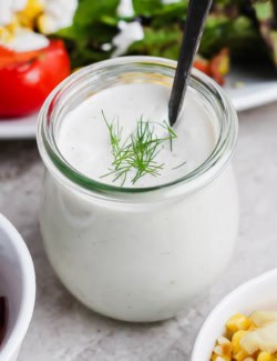 Jar of buttermilk ranch dressing with spoon