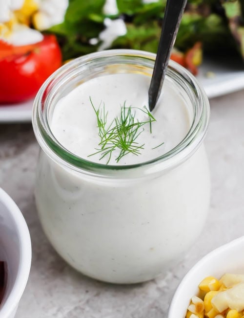 Jar of buttermilk ranch dressing with spoon