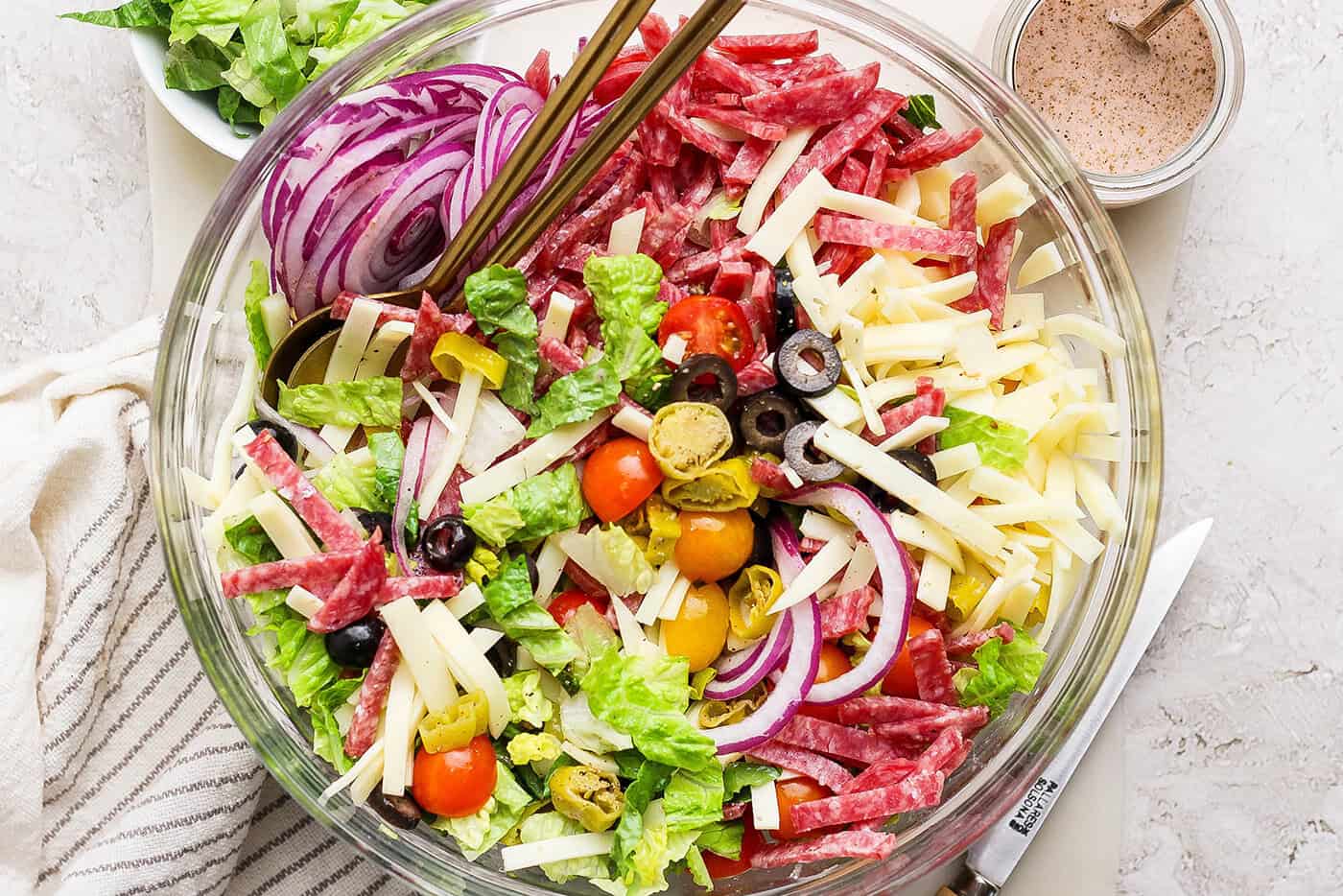 Overhead view of Italian chopped salad in glass bowl