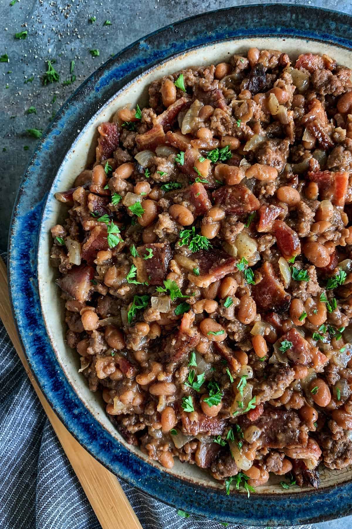 a bowl of baked beans with bacon and ground beef