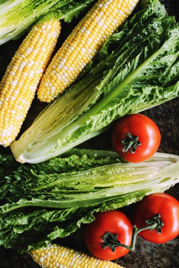 grilled romaine salad has romaine lettuce, tomatoes, and sweet corn