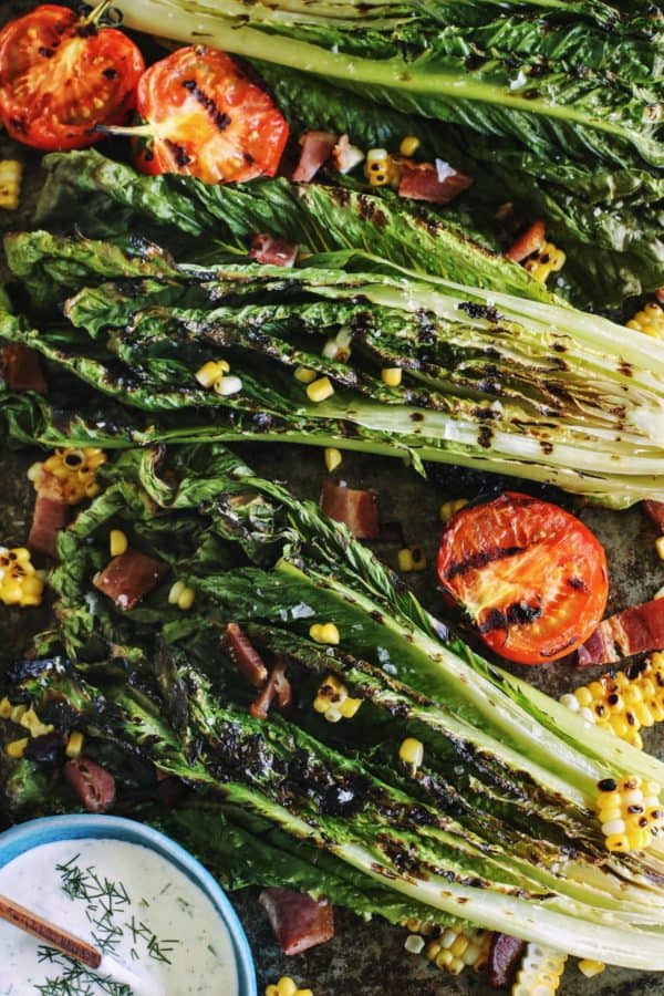 grilled halves of romaine lettuce heads and tomatoes