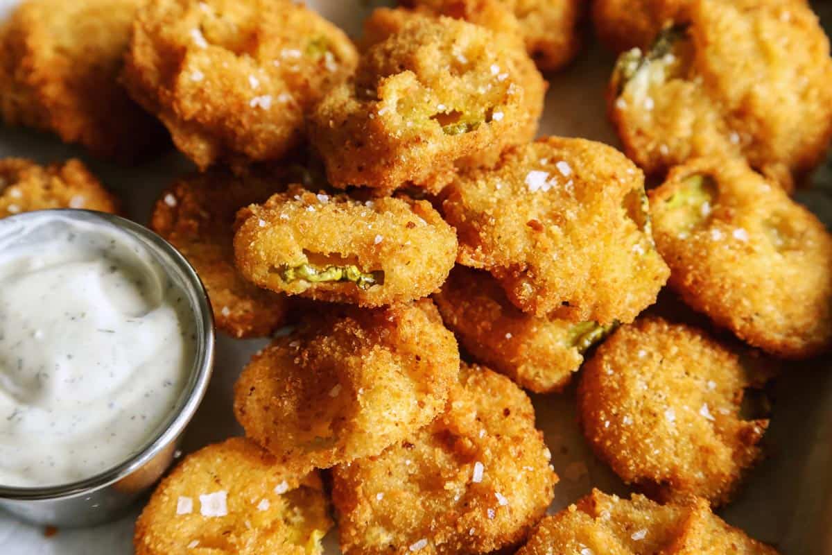 fried pickles on tray with ranch dip