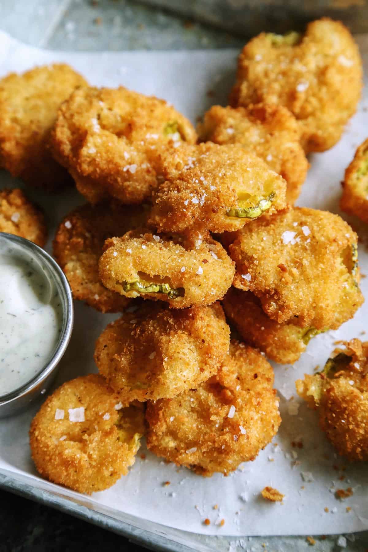 fried pickles with dip on a tray