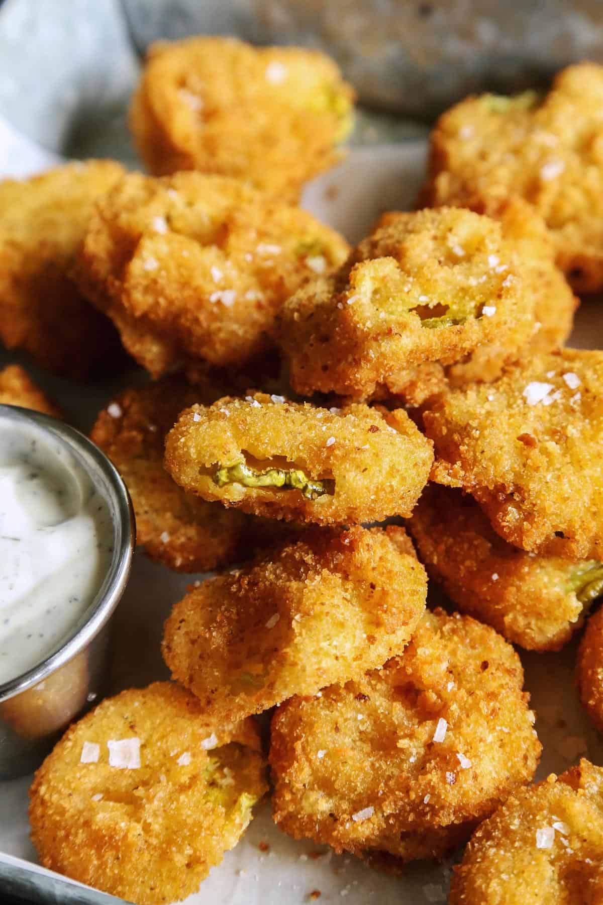 fried pickles on tray with ranch dip