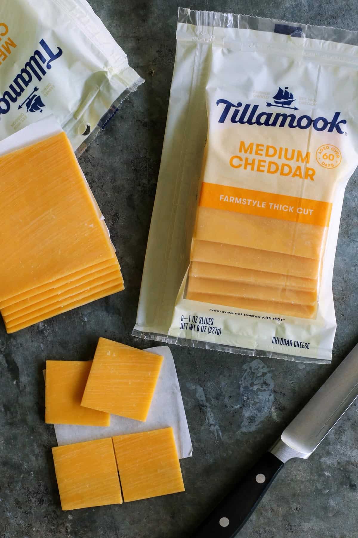 packages of Tillamook farmstyle thick cut medium cheddar slices