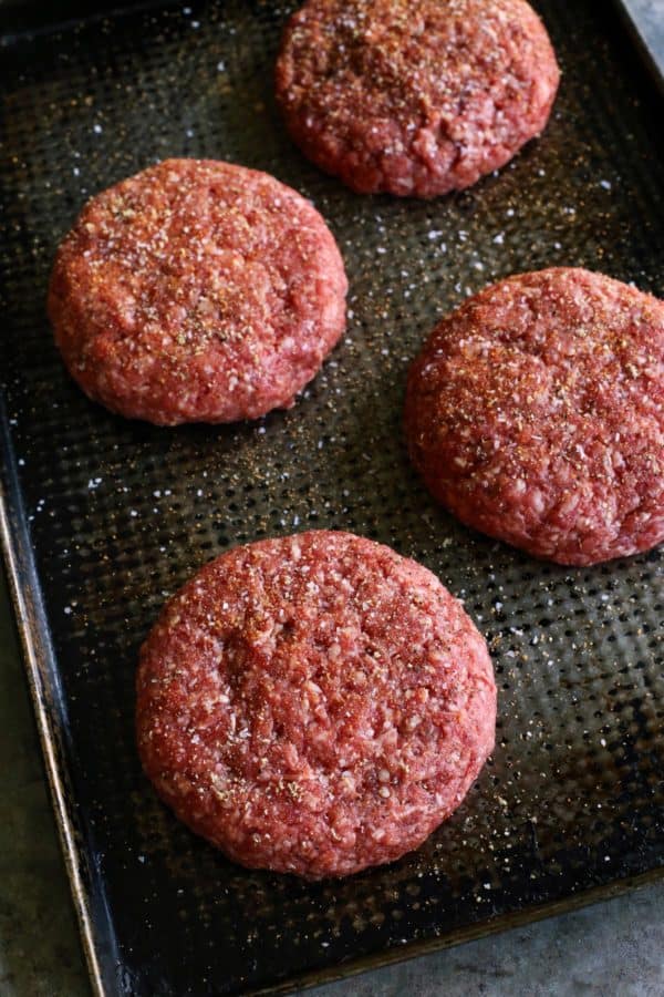 Juicy Lucy burgers on a sheet pan, before grilling
