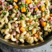 pinterest image of macaroni salad with ham and cheese in stainless steel bowl