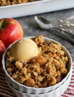 apple crisp with ice cream in a white dish