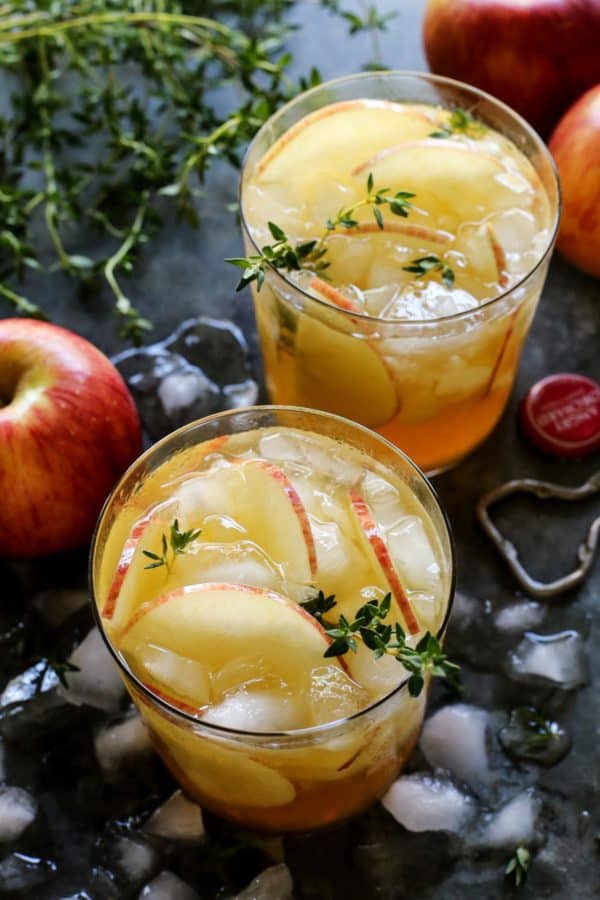 2 glasses of apple sangria and a few fresh apples