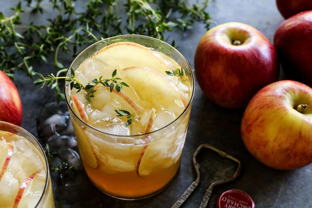 a glass of apple sangria, plus apples