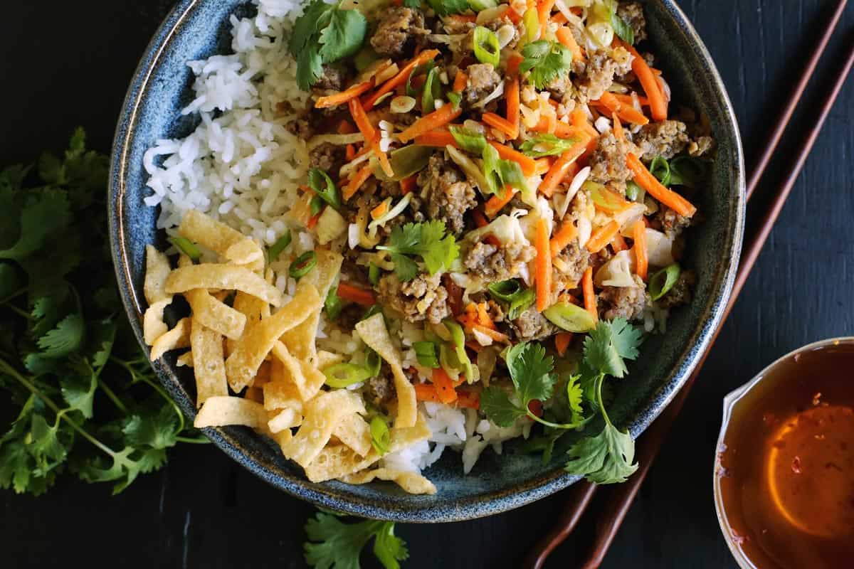 a blue bowl filled with deconstructed egg roll