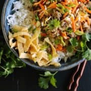 pinterest image of egg roll flavors of ground pork, cabbage, and carrots served in a bowl over white rice
